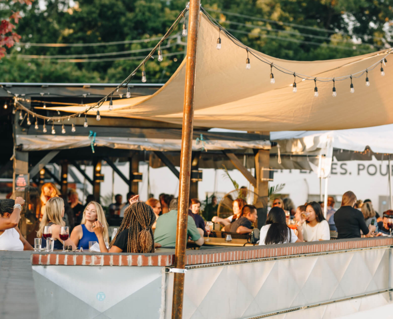 A full patio on a beautiful sunny day at Wye Hill Brewing in Downtown Raleigh
