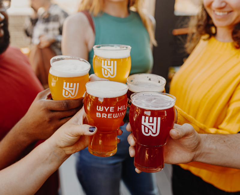 Guests toasting Wye Hill beers at a corporate networking event in Raleigh, NC
